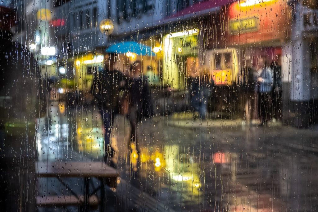 a person walking down a wet street